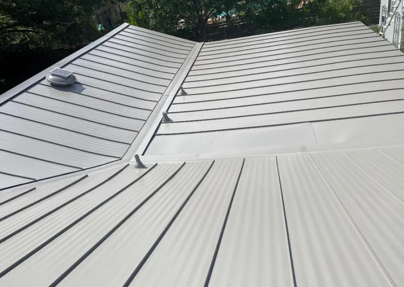 Solar attic fan installed on a metal roof for Roof Ventilation in Baton Rouge